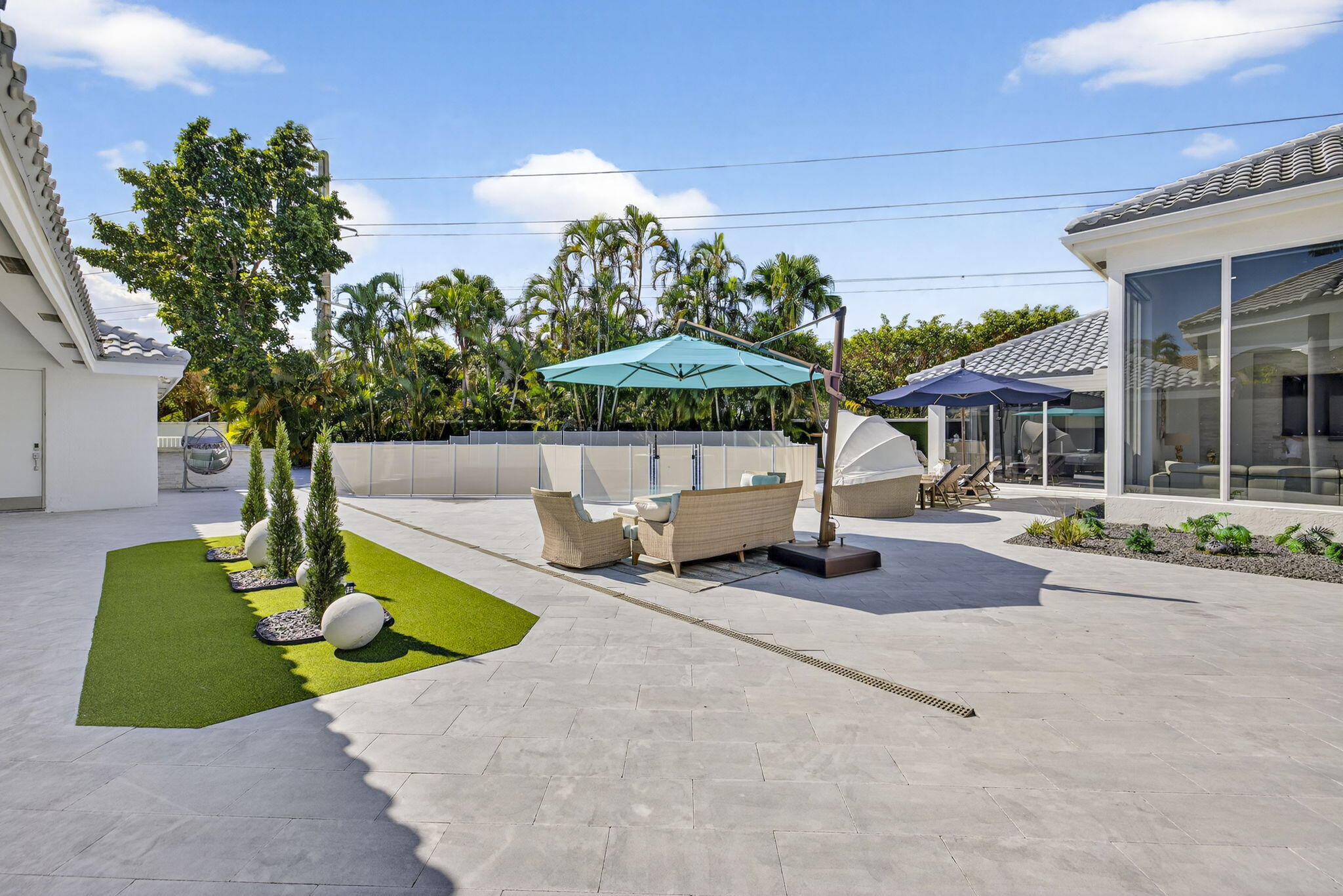 2673 Northwest 64th Boulevard Boca Raton, FL 33496 - Photo 43 of 64 a view of a house with backyard porch and sitting area