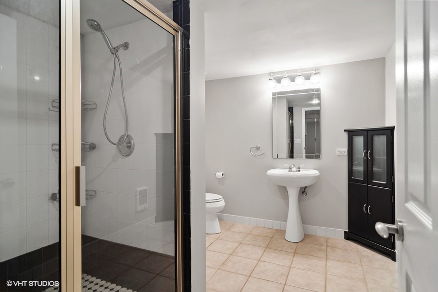 831 Ela Road Inverness, IL 60067 - Photo 15 of 25 a bathroom with a sink toilet and shower