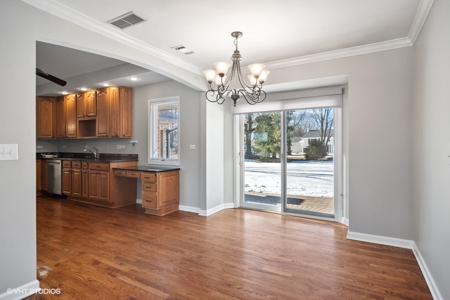 831 Ela Road Inverness, IL 60067 - Photo 22 of 25 a view of a kitchen with granite countertop a stove top oven a sink and dishwasher with wooden floor