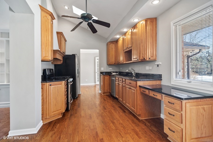 831 Ela Road Inverness, IL 60067 - Photo 4 of 25 a kitchen with stainless steel appliances granite countertop a stove a sink and a refrigerator
