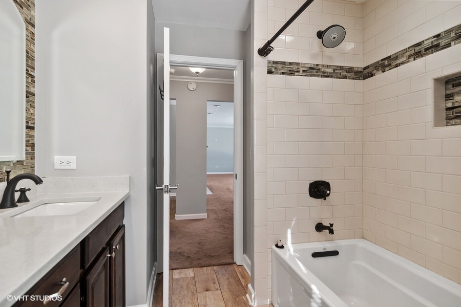 831 Ela Road Inverness, IL 60067 - Photo 10 of 25 a bathroom with a tub a sink and mirror