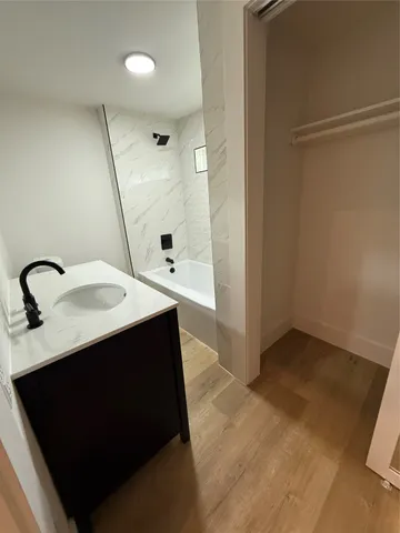 a kitchen with a sink and a mirror