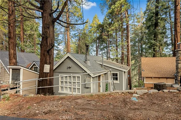 a view of a house with wooden fence