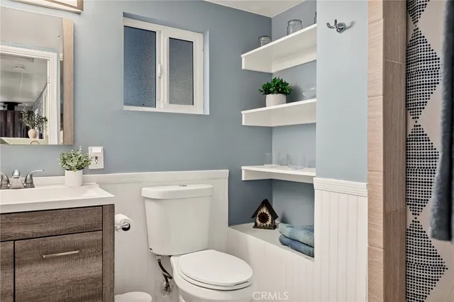 a bathroom with a sink vanity and toilet