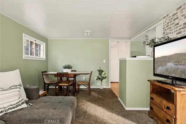 a workspace with furniture and a refrigerator