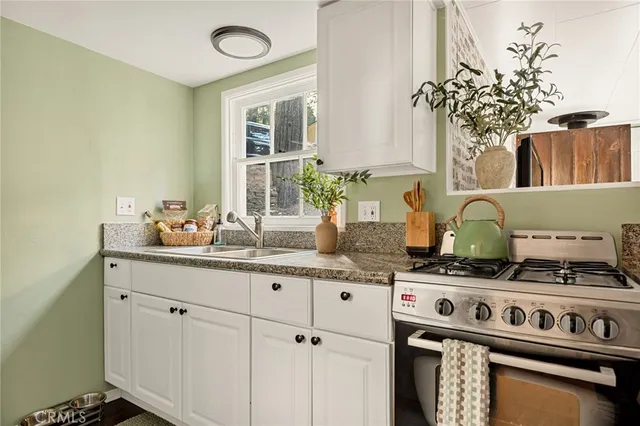 a kitchen with a sink stove and cabinets