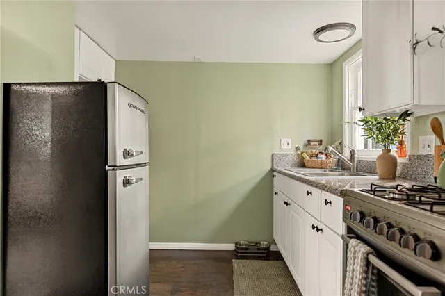 a kitchen with stainless steel appliances granite countertop a refrigerator and a stove