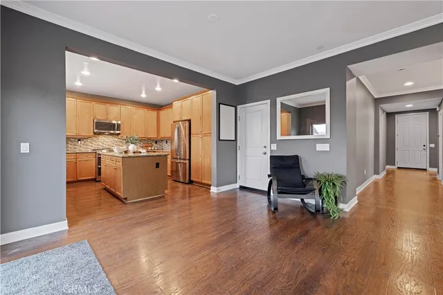 a view of kitchen with microwave a stove and wooden floor