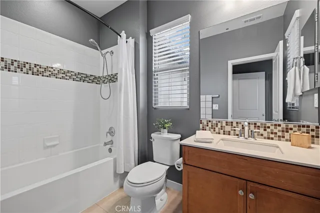 a bathroom with a sink toilet a mirror and shower