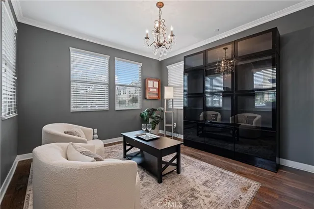 a living room with furniture a chandelier and a window