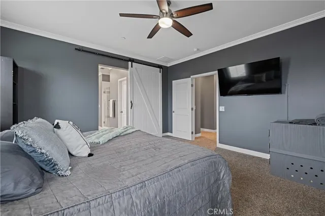 a bedroom with a large bed and a flat screen tv