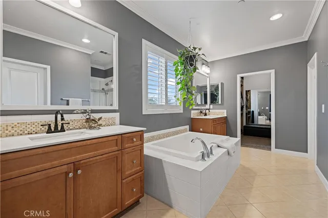 a bathroom with a tub sink and mirror