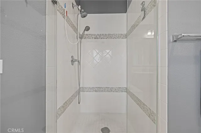 a bathroom with a glass shower door