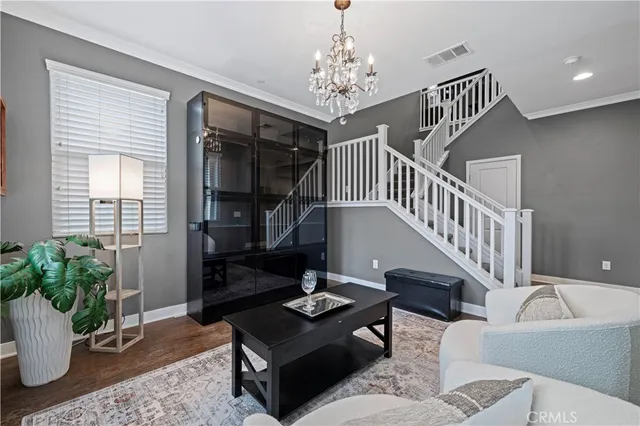 a living room with furniture and a chandelier