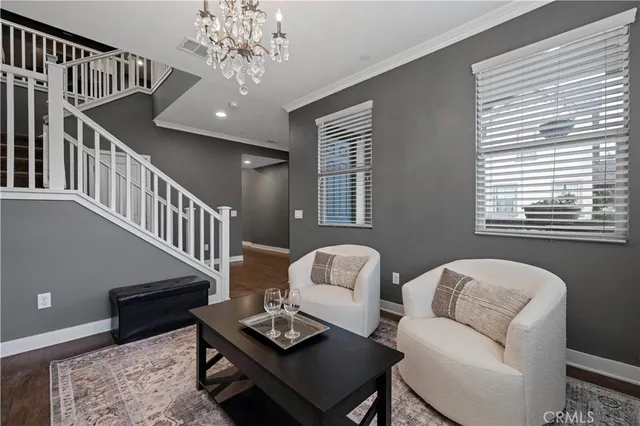 a living room with furniture and a chandelier