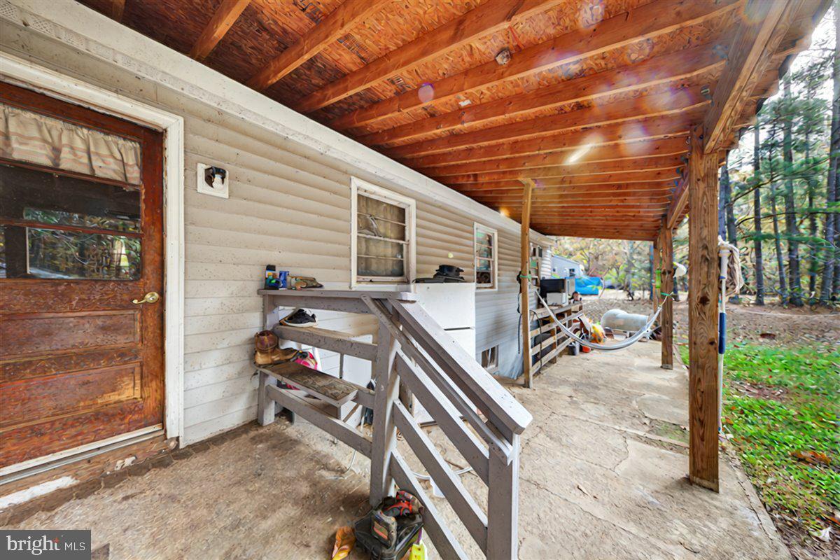 185 Smith Road Mineral, VA 23117 - Photo 15 of 26 a view of a porch with a table and chairs