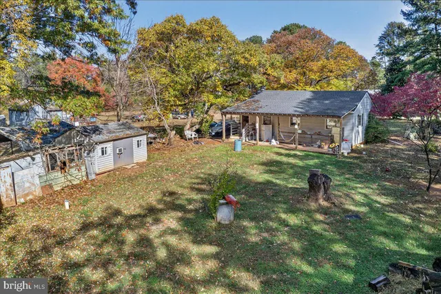 a backyard of a house with barbeque oven and outdoor seating