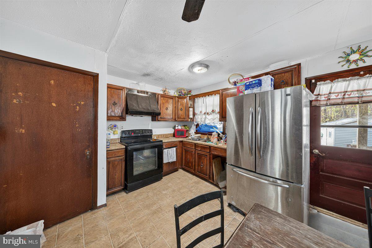185 Smith Road Mineral, VA 23117 - Photo 5 of 26 a kitchen with stainless steel appliances granite countertop a refrigerator stove and sink