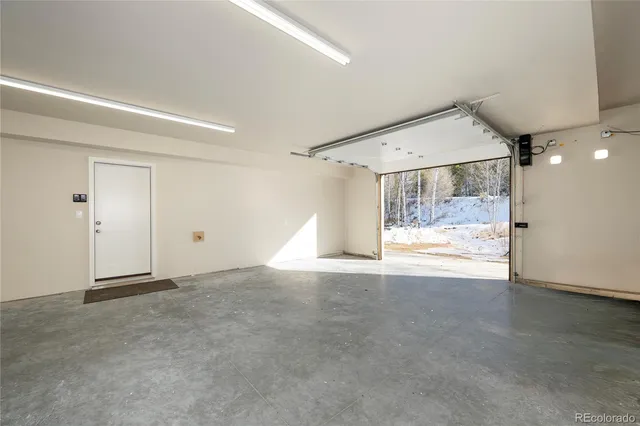 a bedroom with a bed and a lamp