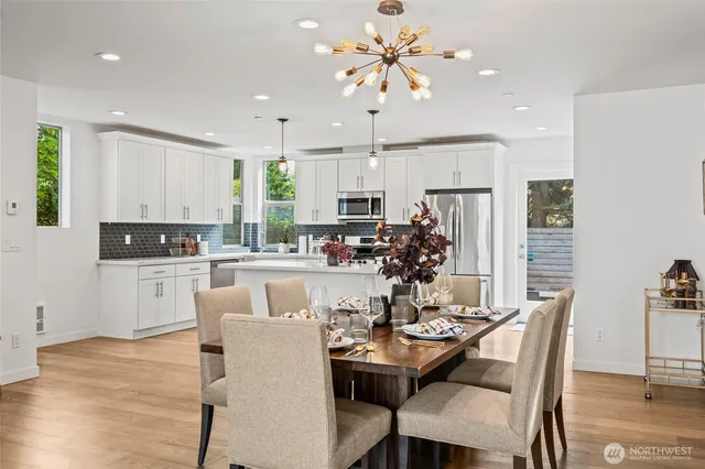 a kitchen with kitchen island granite countertop a white cabinets and chairs