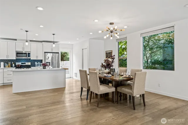 a view of a dining room with furniture window and wooden floor