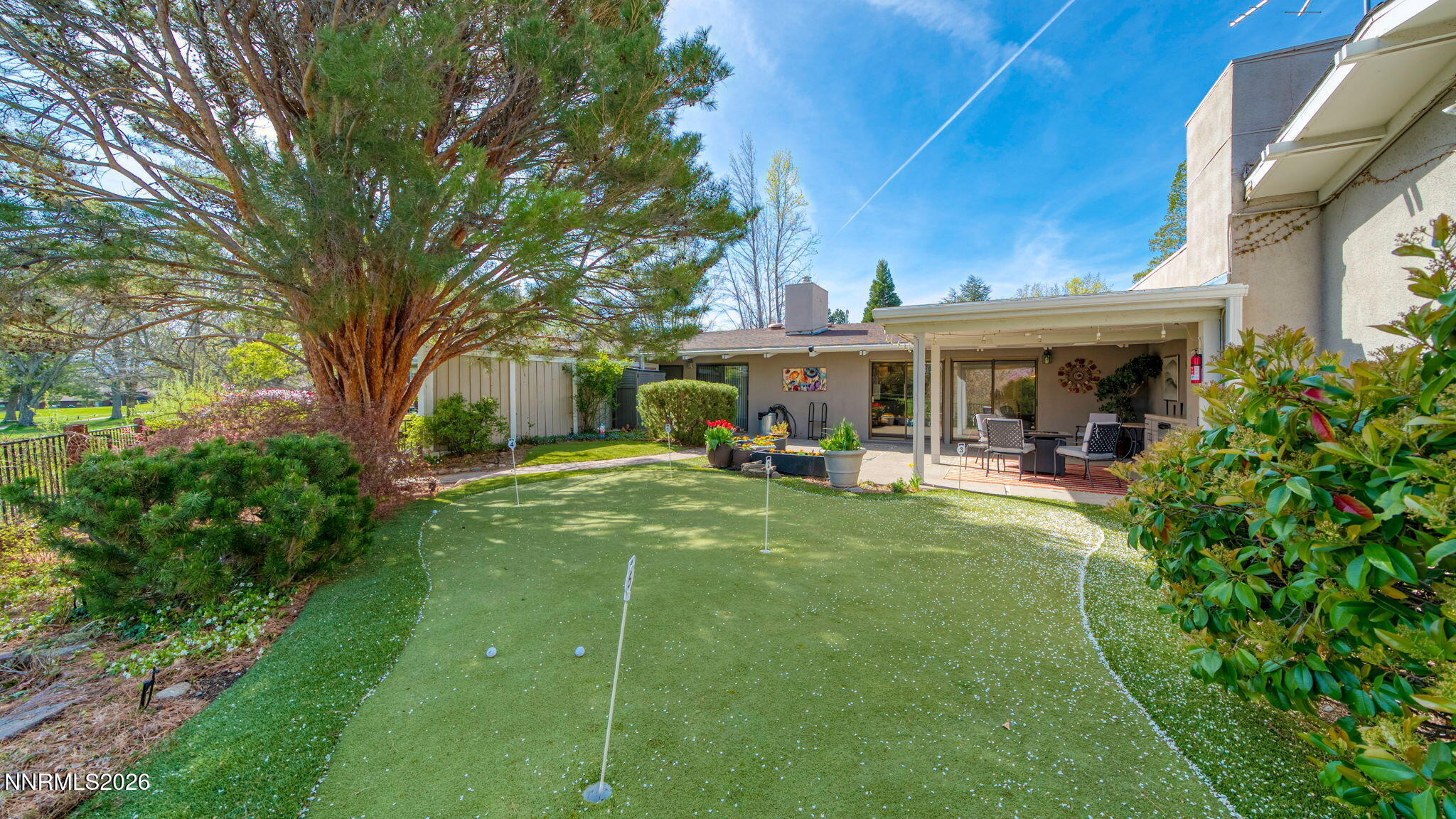 4920 Plumas Street Reno, NV 89509 - Photo 29 of 36 a view of a house with backyard porch and sitting area