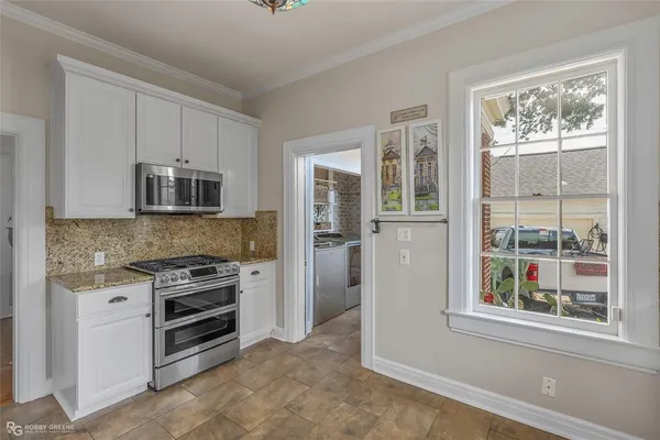 a kitchen with stainless steel appliances a stove sink and microwave