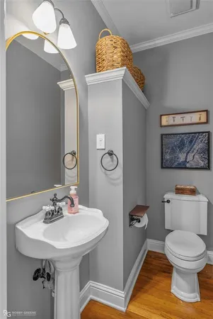 a bathroom with a toilet a sink and mirror