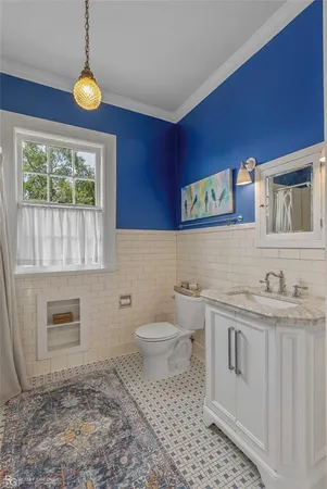 a bathroom with a toilet a sink and a window