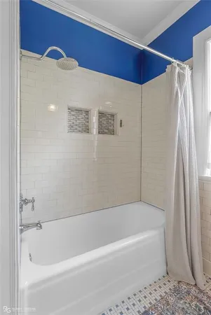 a bathroom with a bathtub and a shower