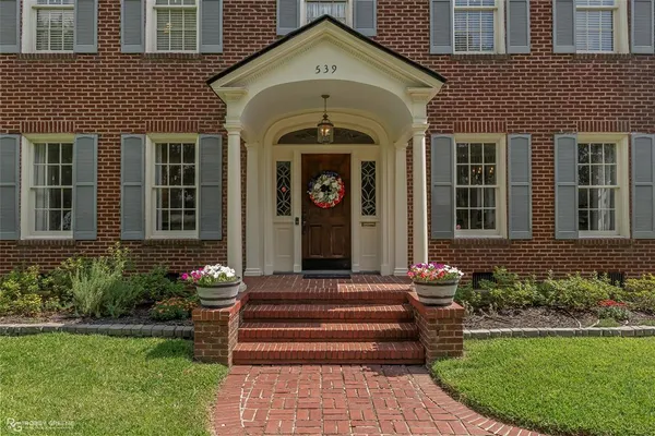 a front view of a house with garden