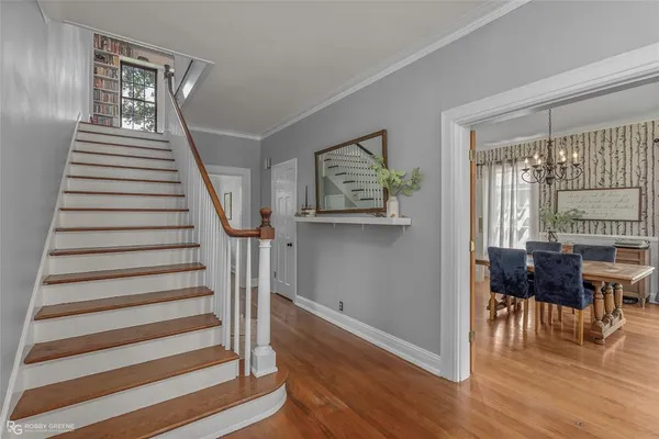 a view of entryway and hall with wooden floor