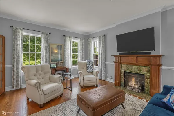 a living room with furniture a flat screen tv and a fireplace
