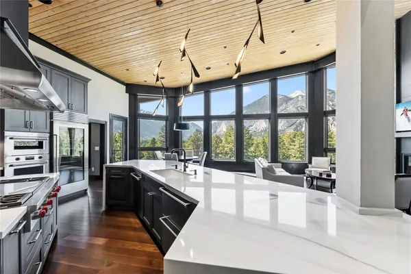 a large kitchen with stainless steel appliances granite countertop a lot of counter space and a dining table