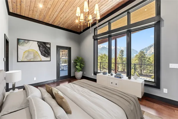 a bedroom with a large bed and a large window