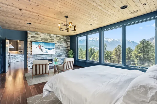 a bed sitting in a spacious bedroom next to a window