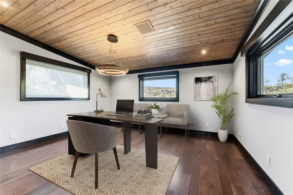 a living room with granite countertop furniture a table and kitchen view