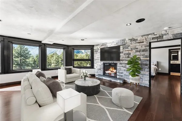 a living room with furniture and wooden floor