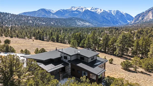 a view of a backyard with a mountain view and sitting space