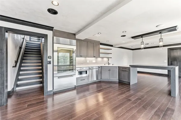 an empty room with windows and fireplace