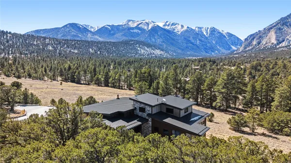 a view of a house with a yard and mountain