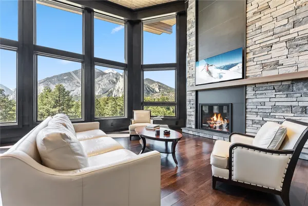 a living room with furniture fireplace and a large window