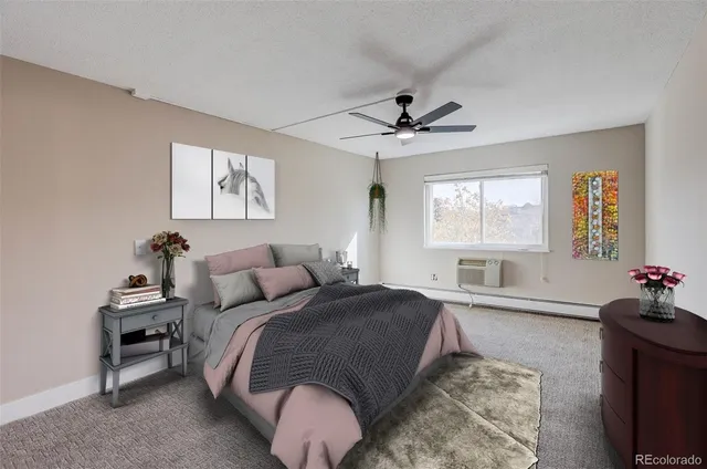 a spacious bedroom with a bed a chandelier and a window
