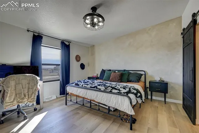 a bedroom with a bed and a chair