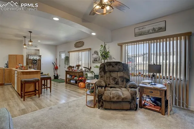 a living room with furniture and kitchen view