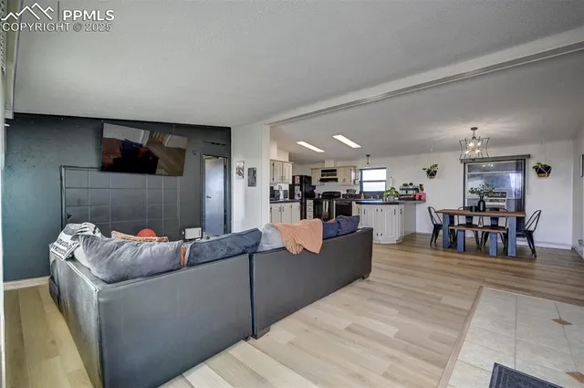 a living room with furniture and kitchen view