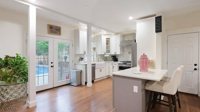 a kitchen with stainless steel appliances a stove sink and refrigerator