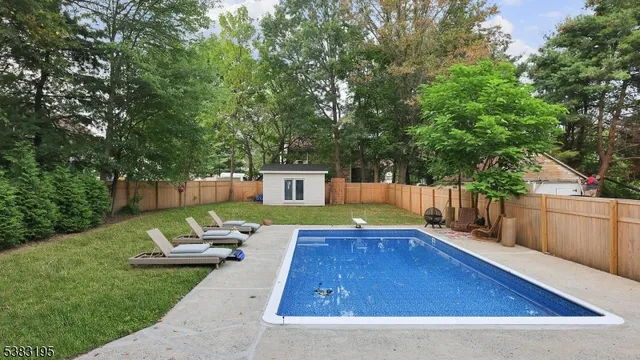 a view of a backyard with swimming pool