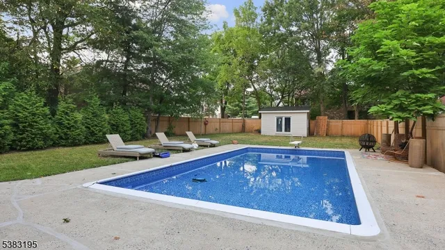 a view of a house with swimming pool and sitting area