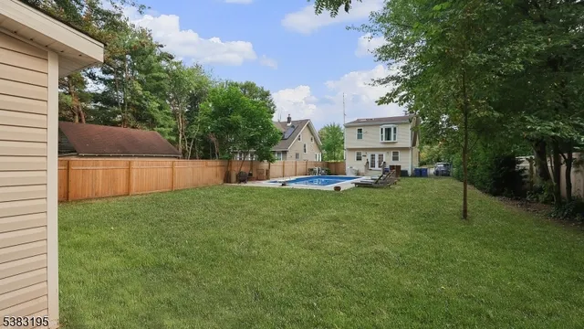a view of a house with backyard and a tree